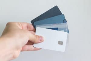 Hand holding credit cards, Personal Loan to Pay Off Debt