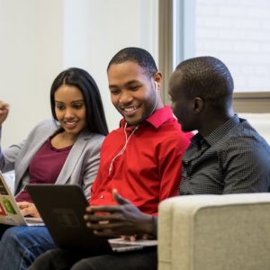 Friends look over data on laptops