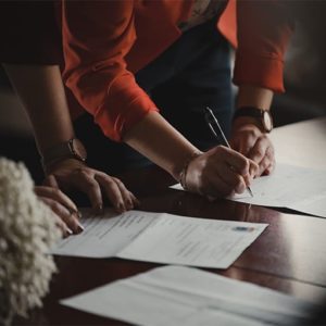 Two people signing documents