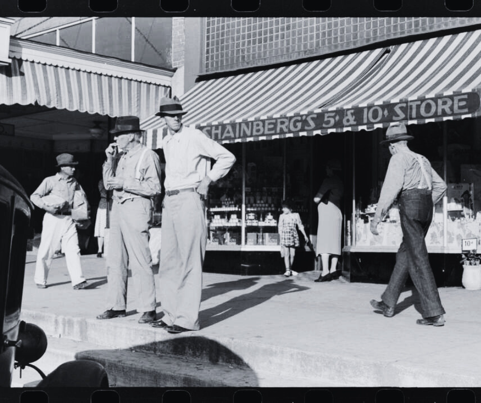 Tower Loan History 2 Black and White photo. People on a sidewalk outside of a store.